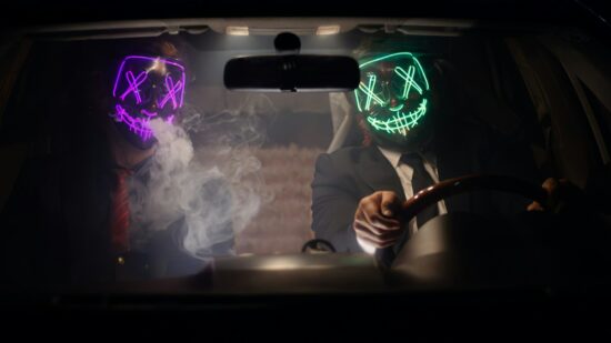 Neon mask guys chilling inside car
