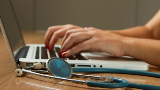 Stethoscope and Laptop Computer. Laptop computers and other kinds of mobile devices and communications technologies are of increasing importance in the delivery of health care. Photographer Daniel Sone