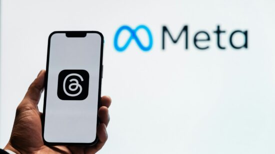 Young man using new meta threads app on smartphone