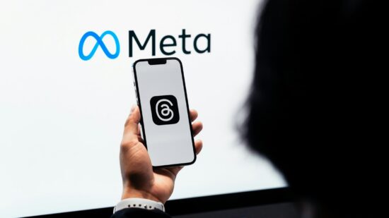 Young man using new meta threads app on smartphone