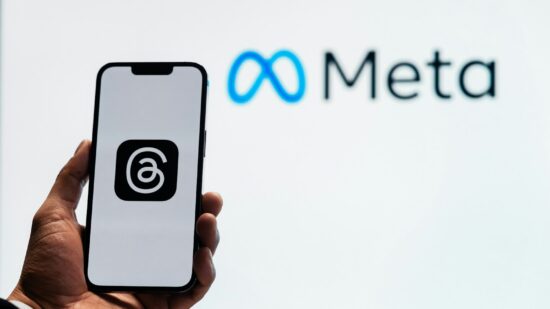 Young man using new meta threads app on smartphone